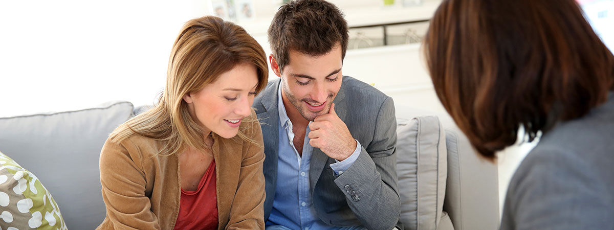 A young couple consulting with a dealer