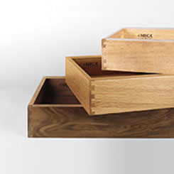 Stack of cabinet drawers in various wood species