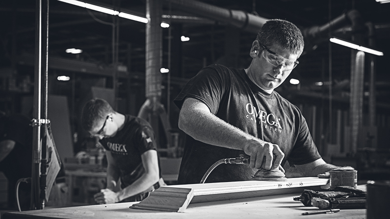 Two production associates working in the Omega plant