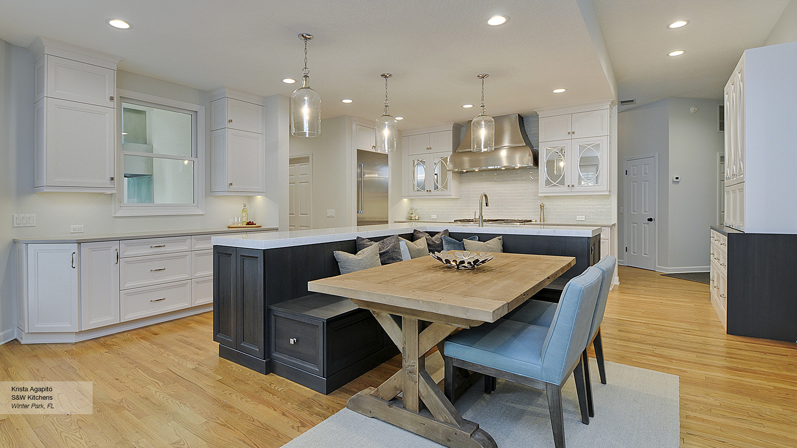 Kitchen Featuring An Island With Bench Seating Omega
