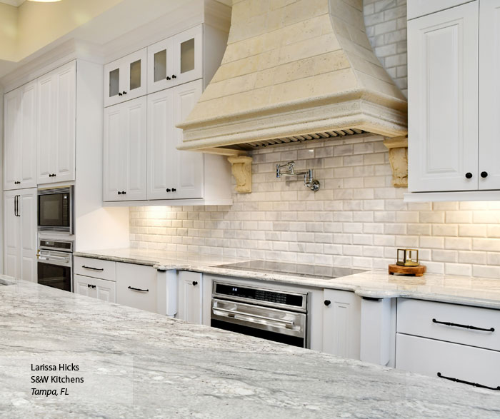 Kitchen With White Cabinets And A Gray Island Omega