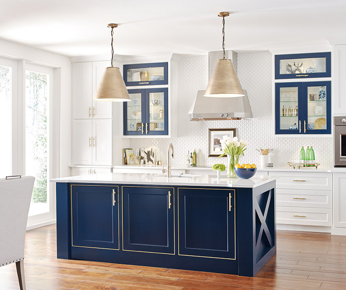 White kitchen cabinets with a custom blue kitchen island in the Renner door style