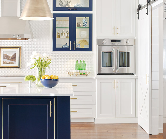 White kitchen cabinets with a custom blue kitchen island in the Renner door style