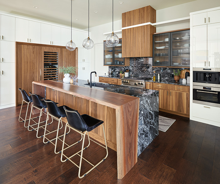 modern kitchen with wooden cabinetry and black bartstools