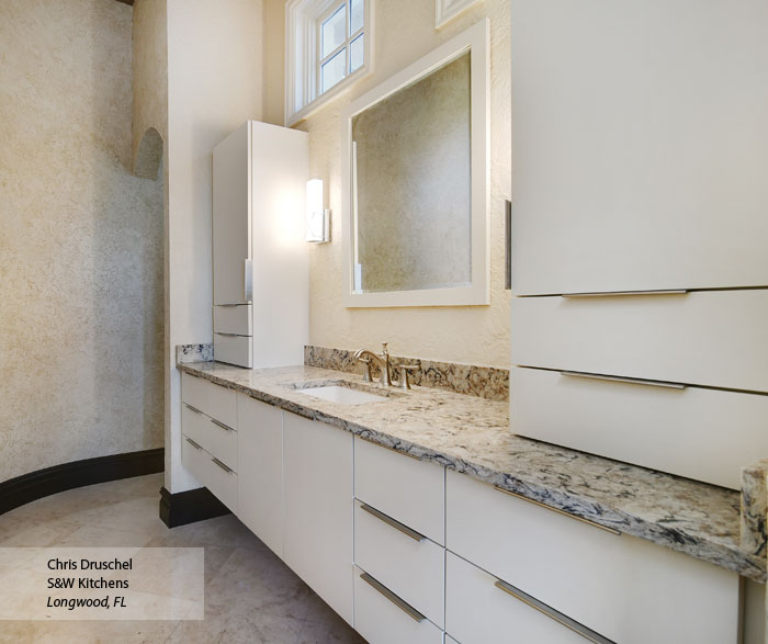 Modern bathroom with Vail slab cabinet doors in Maple Dove finish